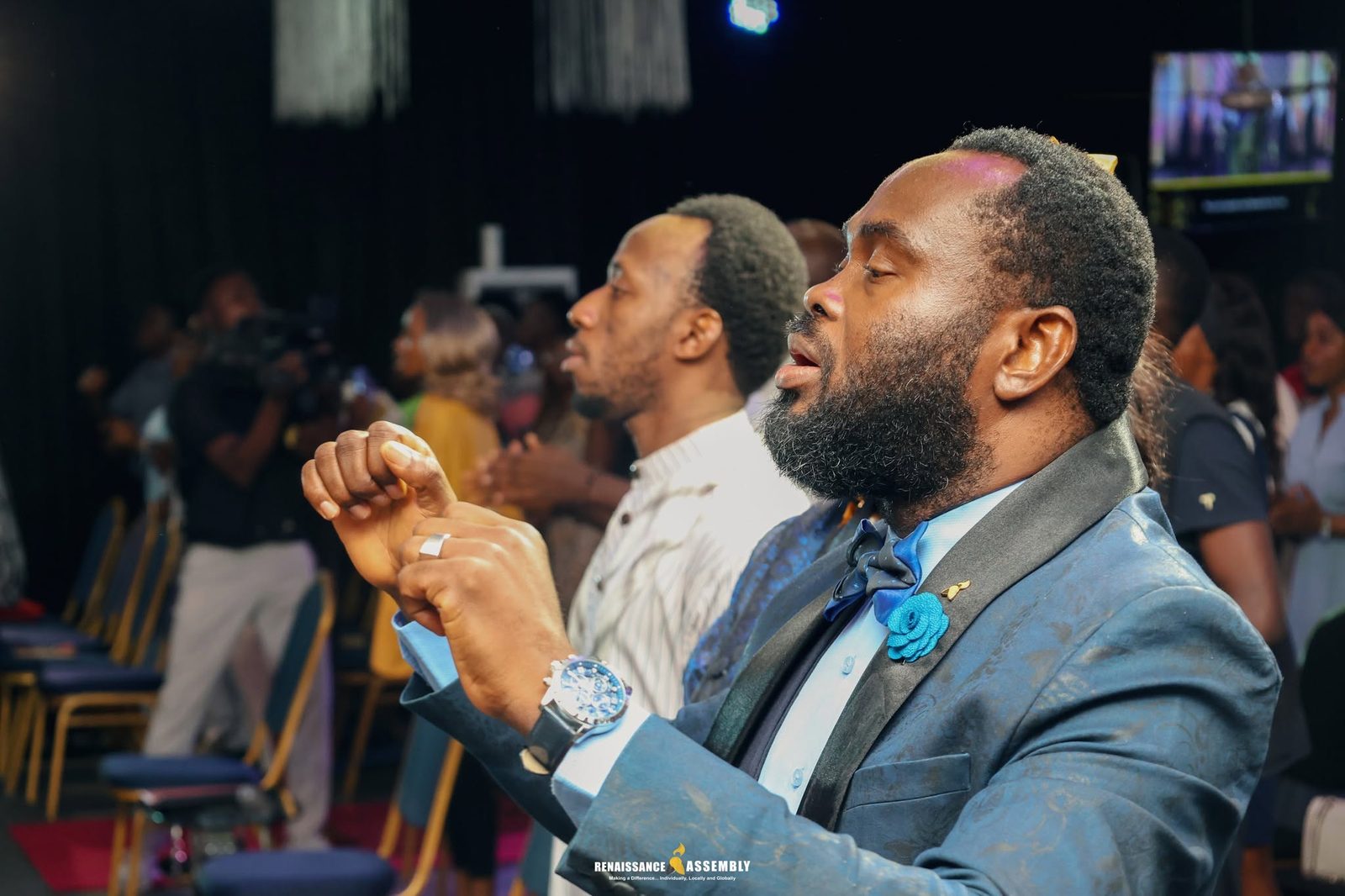 A worshipper singing with eyes closed during a service